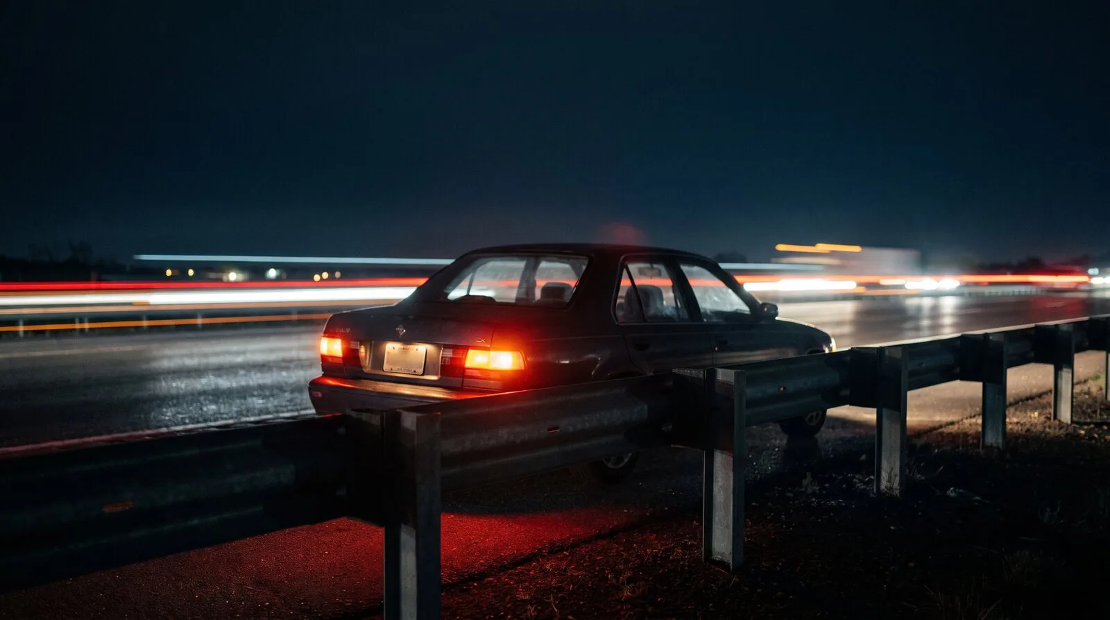 A car stopped on the shoulder of a road
